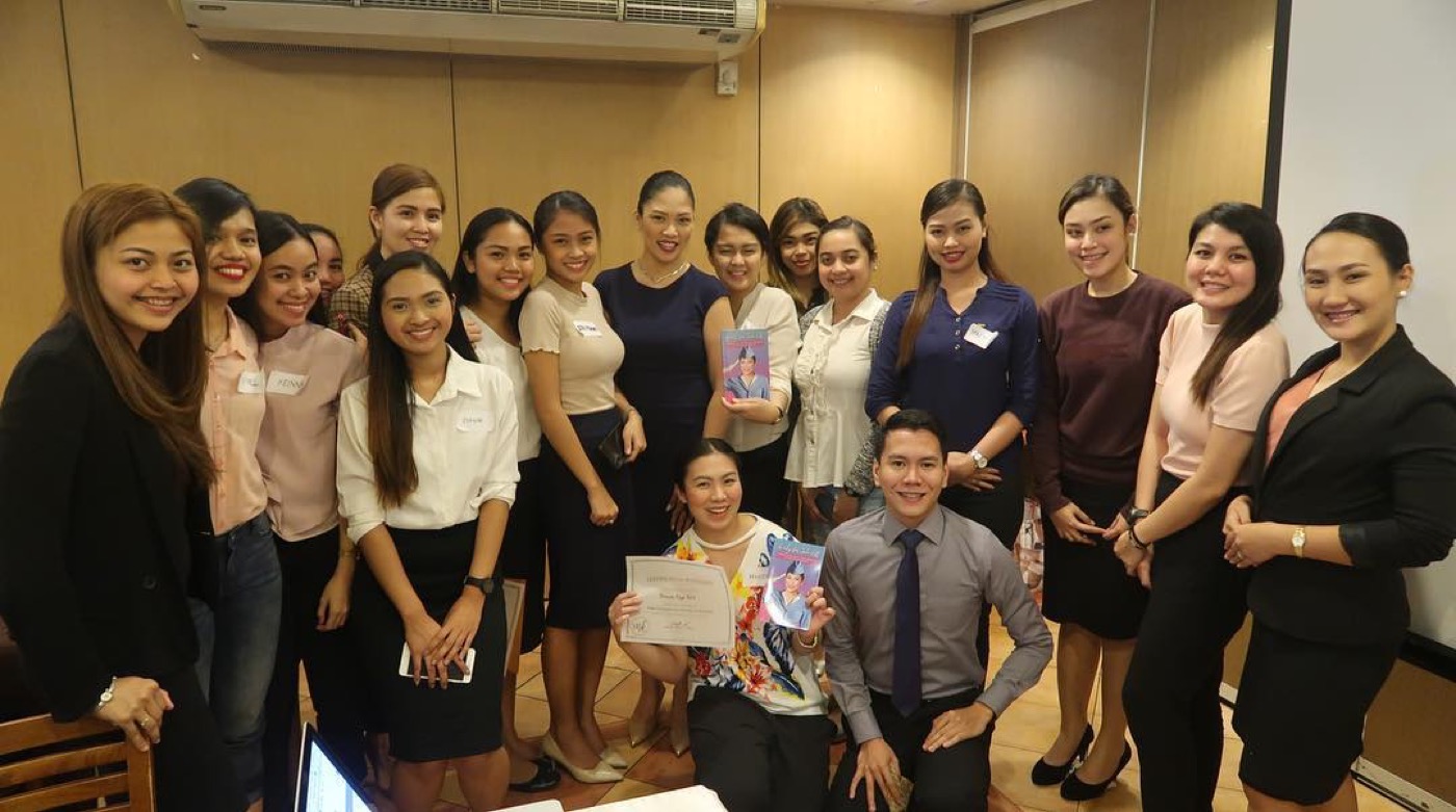 Miss Kaykrizz in-person cabin crew preparation class holding Ready for Take-Off books