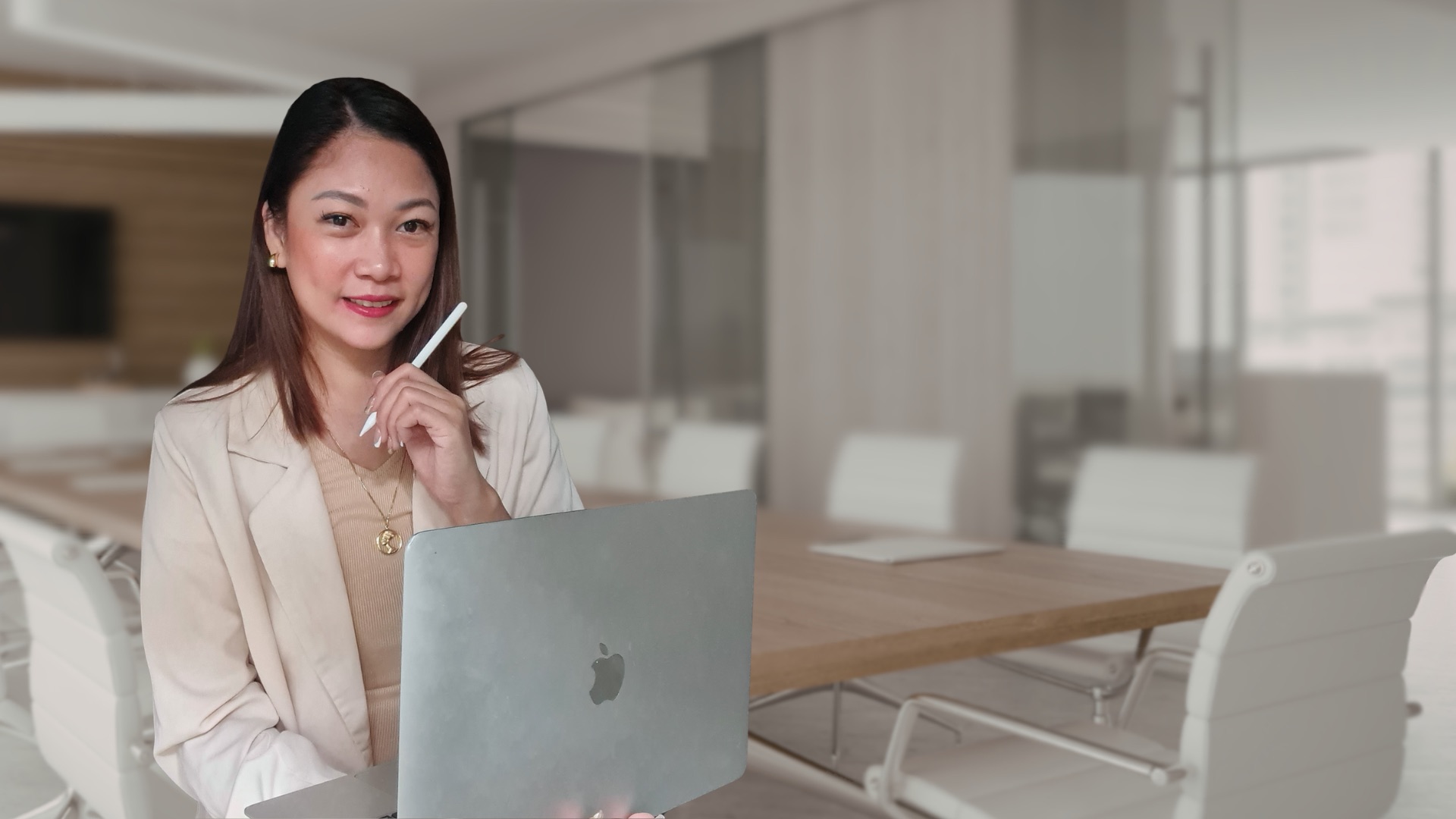 Ruth Maclang seated with a laptop in a boardroom
